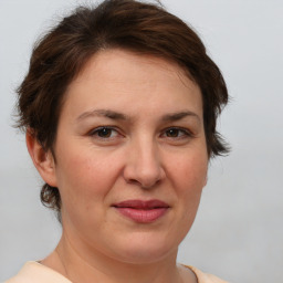 Joyful white adult female with short  brown hair and brown eyes