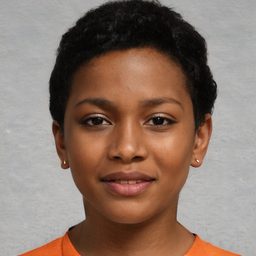 Joyful black child female with short  black hair and brown eyes