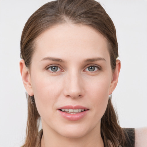 Joyful white young-adult female with long  brown hair and grey eyes