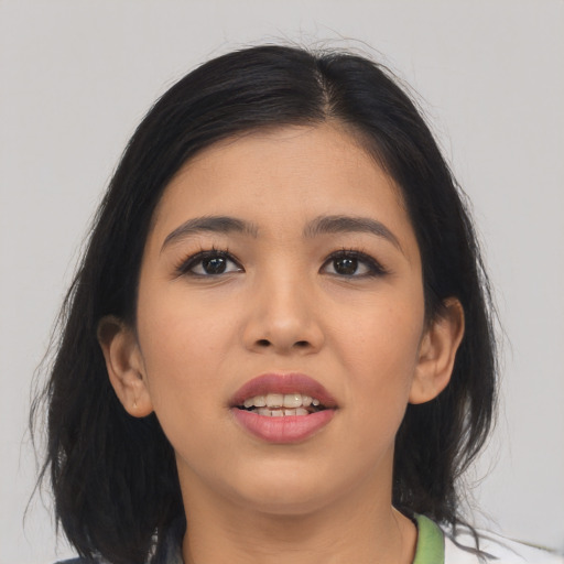 Joyful asian young-adult female with medium  black hair and brown eyes