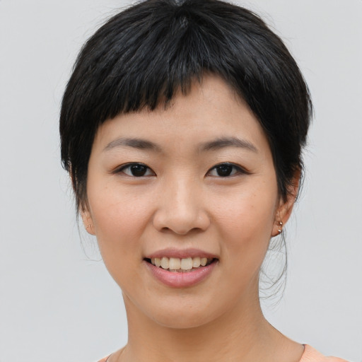 Joyful asian young-adult female with medium  brown hair and brown eyes