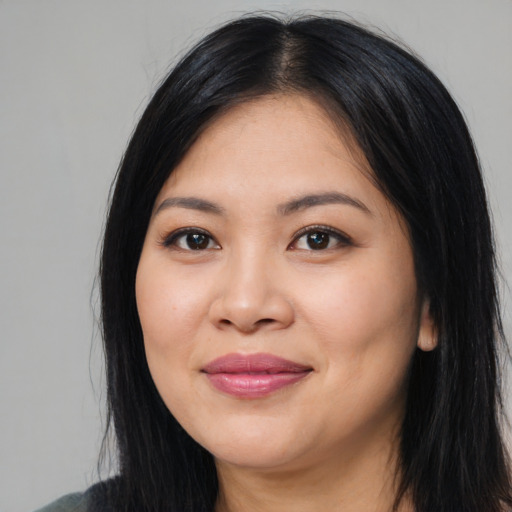 Joyful asian young-adult female with long  black hair and brown eyes