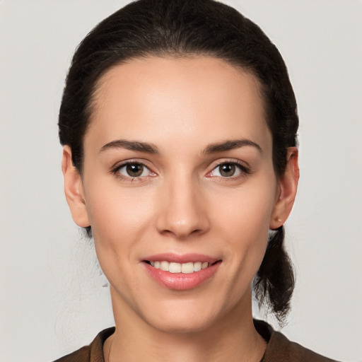 Joyful white young-adult female with medium  brown hair and brown eyes