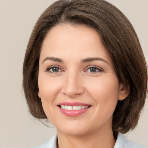 Joyful white young-adult female with medium  brown hair and brown eyes