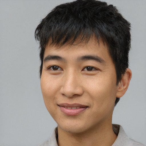 Joyful asian young-adult male with short  brown hair and brown eyes