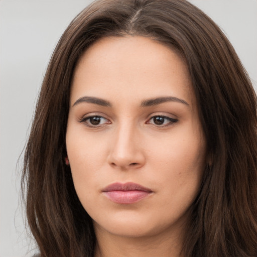 Neutral white young-adult female with long  brown hair and brown eyes