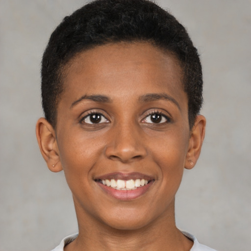 Joyful black young-adult female with short  brown hair and brown eyes