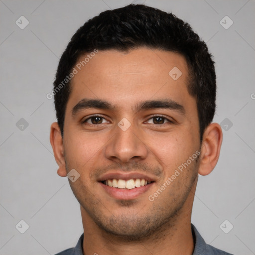 Joyful latino young-adult male with short  brown hair and brown eyes