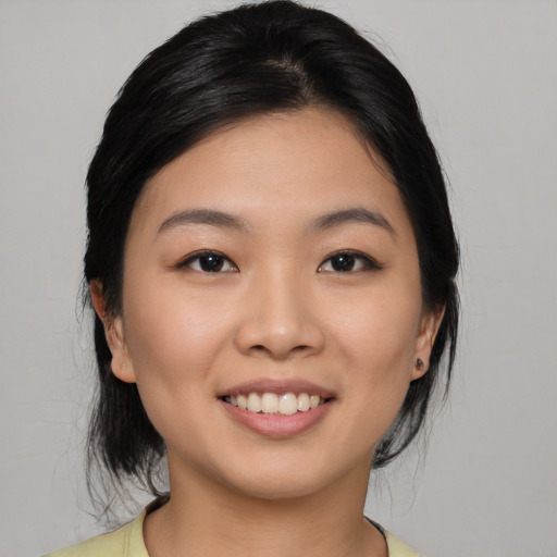 Joyful asian young-adult female with medium  black hair and brown eyes
