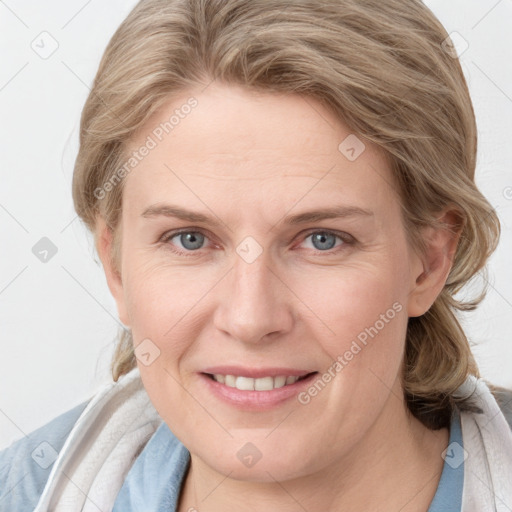 Joyful white young-adult female with medium  brown hair and blue eyes