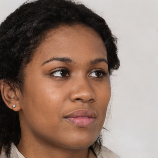 Neutral black young-adult female with long  brown hair and brown eyes