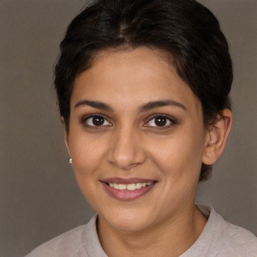 Joyful white young-adult female with short  brown hair and brown eyes