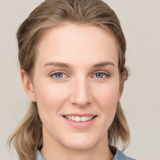 Joyful white young-adult female with medium  brown hair and blue eyes