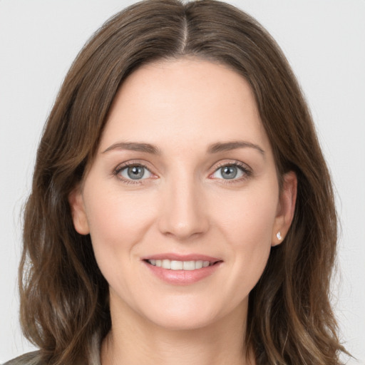 Joyful white young-adult female with long  brown hair and grey eyes