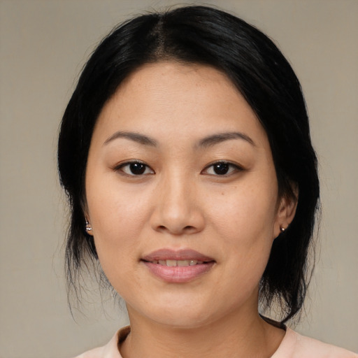 Joyful asian young-adult female with medium  black hair and brown eyes