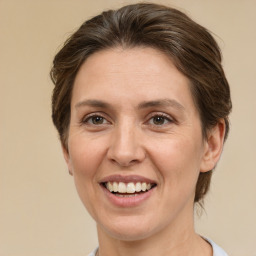 Joyful white adult female with medium  brown hair and brown eyes