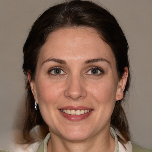 Joyful white adult female with medium  brown hair and brown eyes