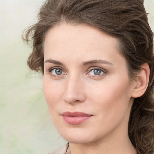 Joyful white young-adult female with medium  brown hair and green eyes