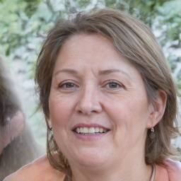 Joyful white adult female with medium  brown hair and blue eyes