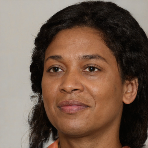 Joyful black adult female with medium  brown hair and brown eyes
