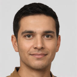 Joyful white young-adult male with short  black hair and brown eyes