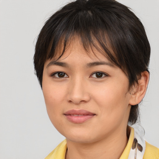 Joyful asian young-adult female with medium  brown hair and brown eyes
