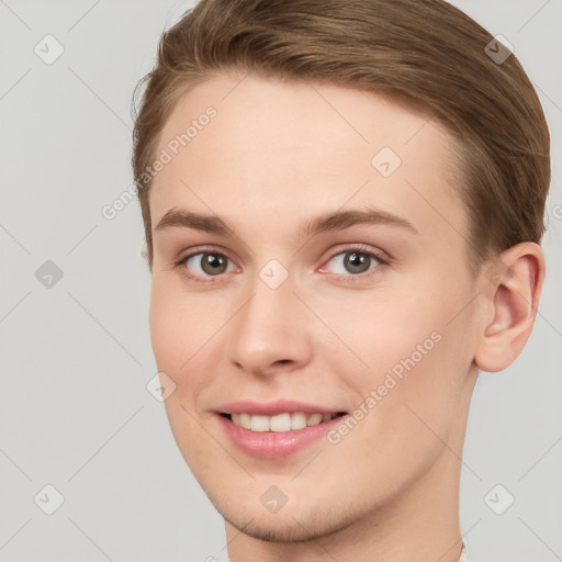 Joyful white young-adult female with short  brown hair and grey eyes