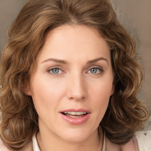 Joyful white young-adult female with medium  brown hair and green eyes