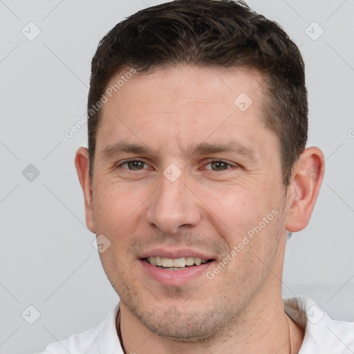 Joyful white adult male with short  brown hair and brown eyes