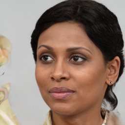 Joyful black young-adult female with medium  brown hair and brown eyes