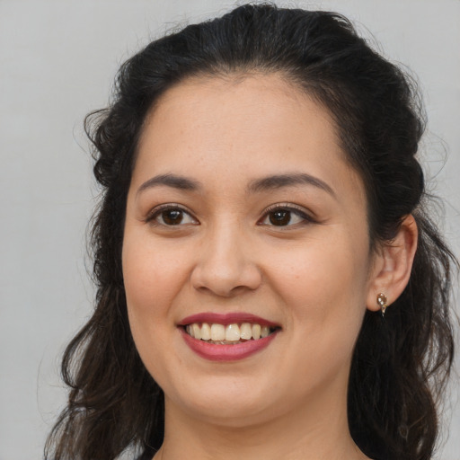 Joyful white young-adult female with long  brown hair and brown eyes