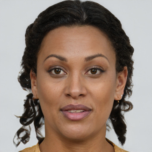 Joyful black young-adult female with short  brown hair and brown eyes