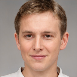 Joyful white young-adult male with short  brown hair and grey eyes