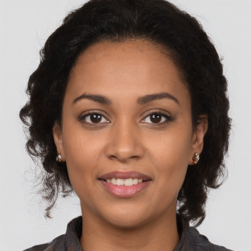 Joyful latino young-adult female with long  brown hair and brown eyes