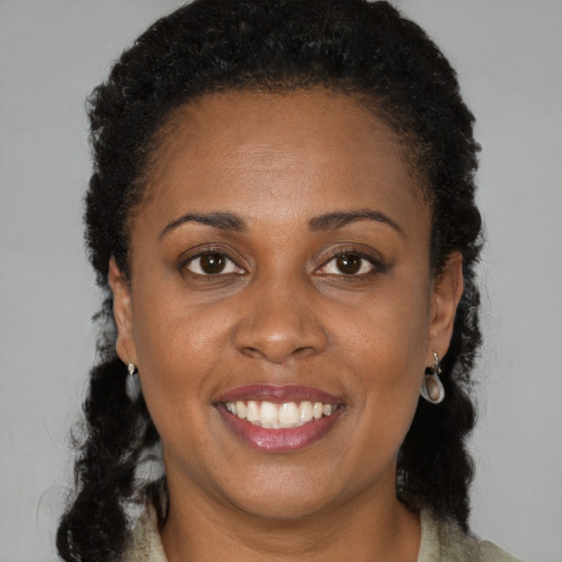 Joyful black young-adult female with short  brown hair and brown eyes