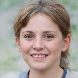 Joyful white young-adult female with medium  brown hair and blue eyes