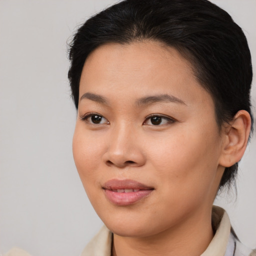 Joyful asian young-adult female with medium  brown hair and brown eyes