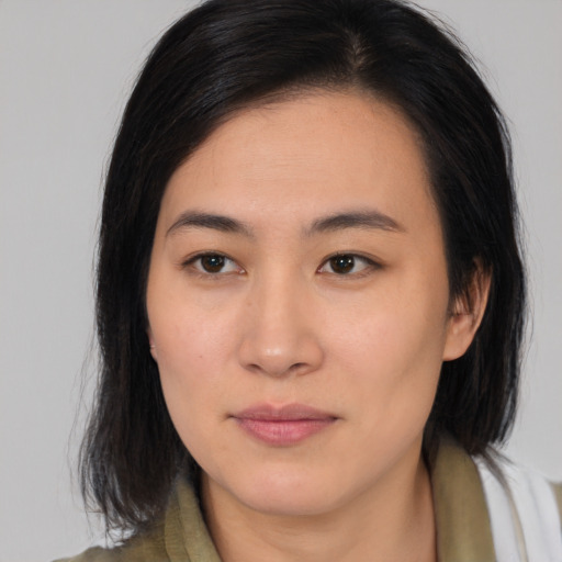 Joyful asian young-adult female with medium  brown hair and brown eyes