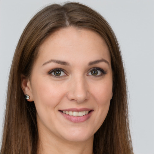 Joyful white young-adult female with long  brown hair and grey eyes