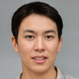 Joyful asian young-adult male with short  brown hair and brown eyes