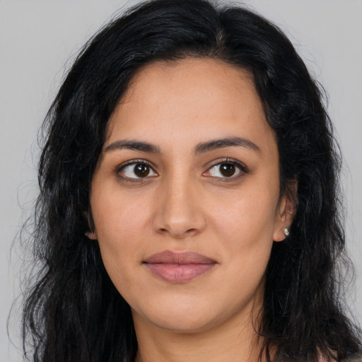 Joyful latino young-adult female with long  black hair and brown eyes