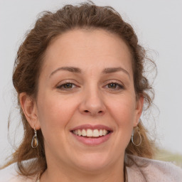 Joyful white adult female with medium  brown hair and grey eyes