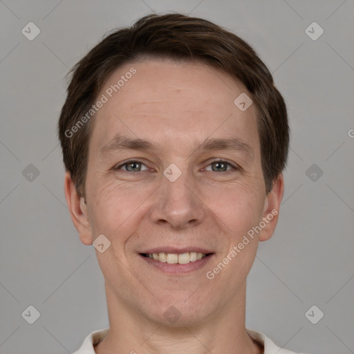 Joyful white adult male with short  brown hair and grey eyes