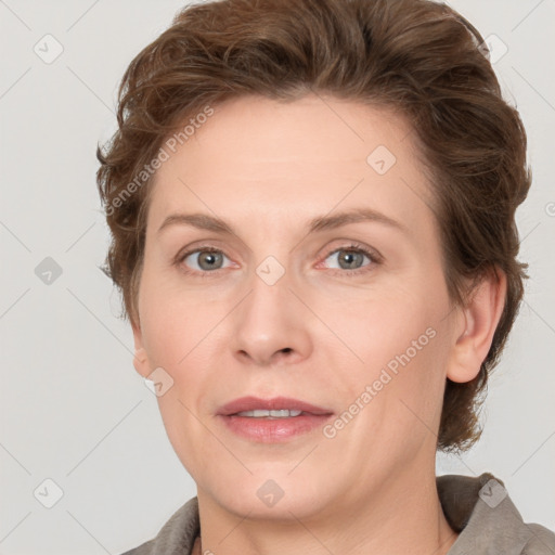 Joyful white adult female with short  brown hair and grey eyes