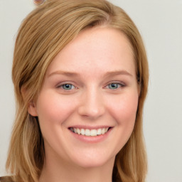 Joyful white young-adult female with long  brown hair and blue eyes