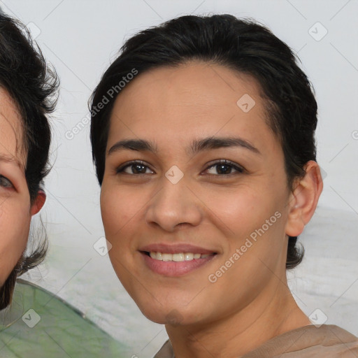 Joyful latino young-adult female with medium  brown hair and brown eyes