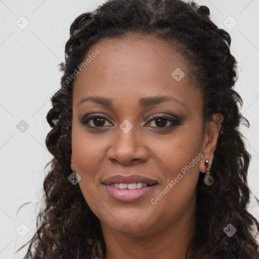 Joyful black young-adult female with long  brown hair and brown eyes