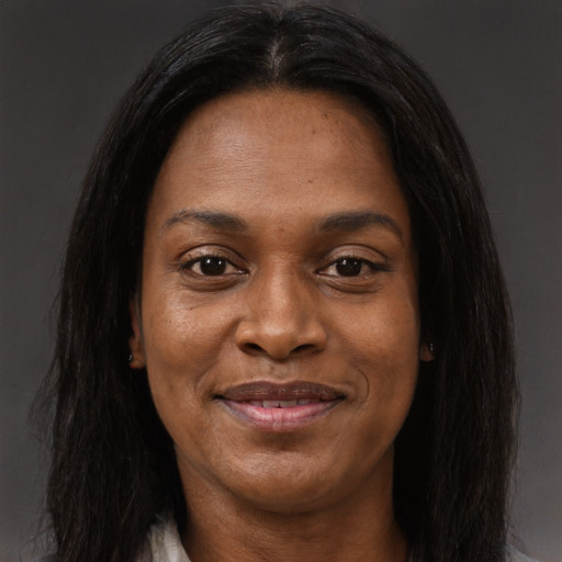 Joyful black adult female with long  brown hair and brown eyes