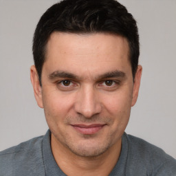 Joyful white adult male with short  brown hair and brown eyes