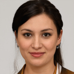 Joyful white young-adult female with medium  brown hair and brown eyes